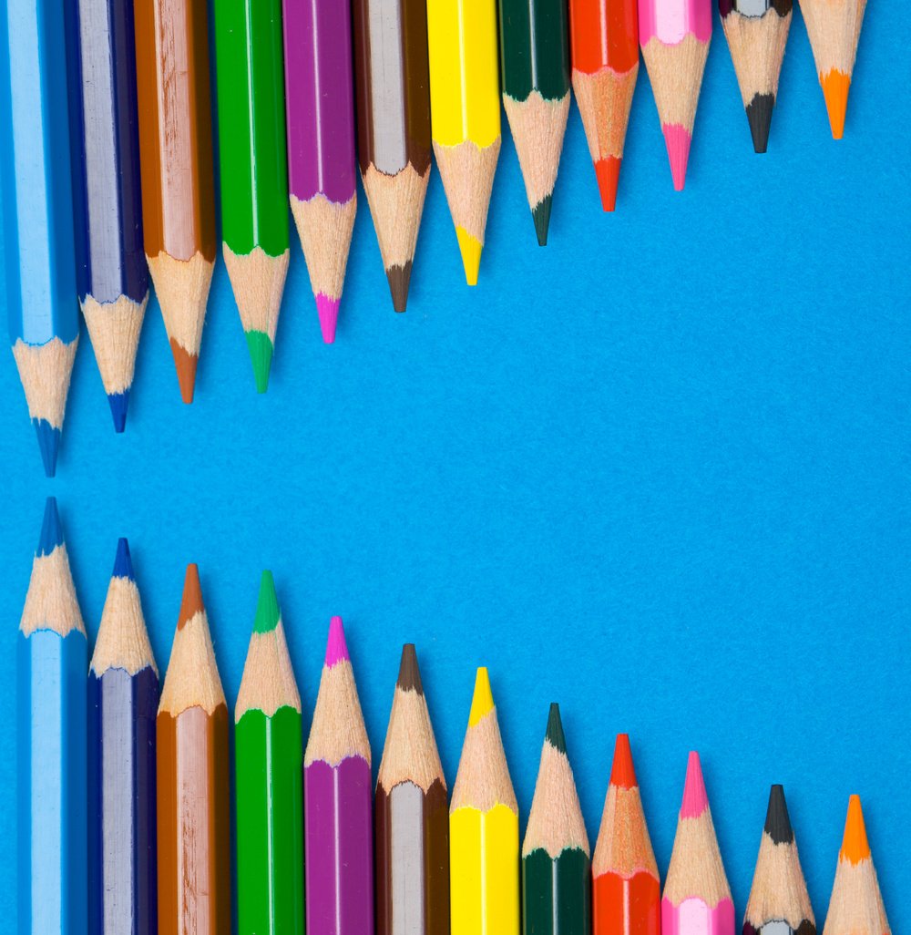 Color Pencils Aligned on Blue